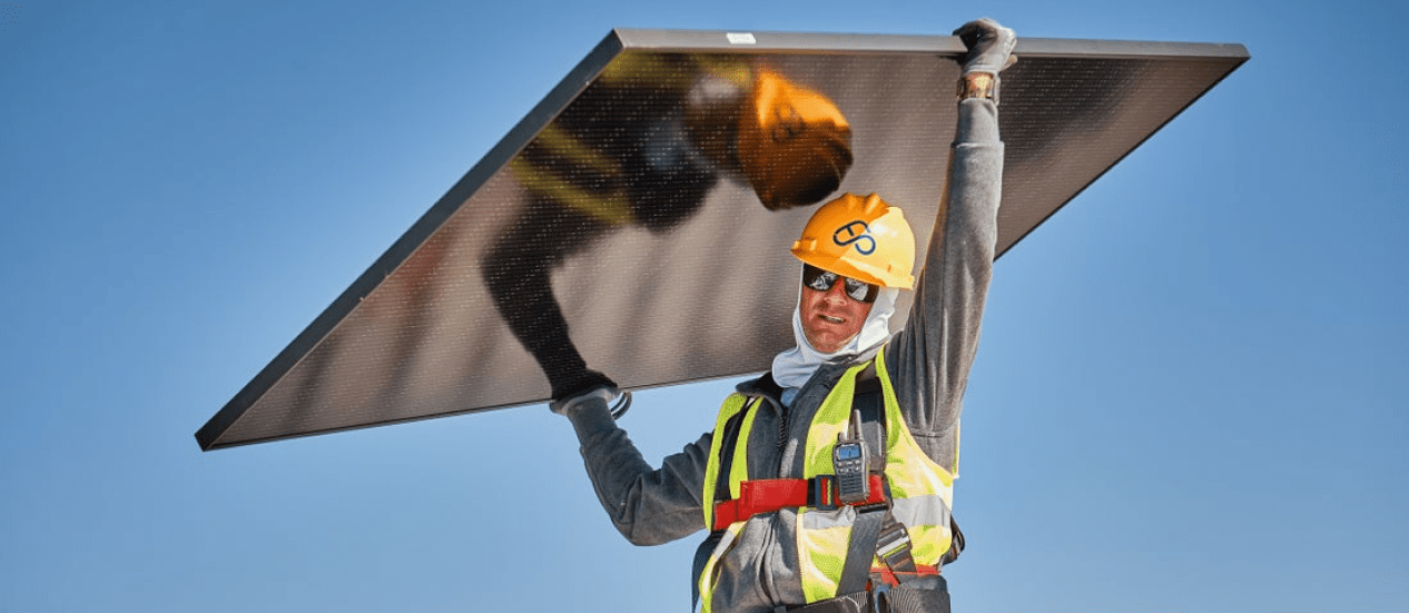 worker carring a solar panel