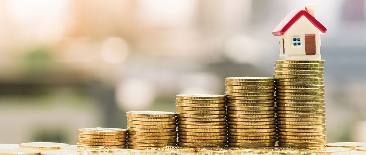 stack of coins with a house on top