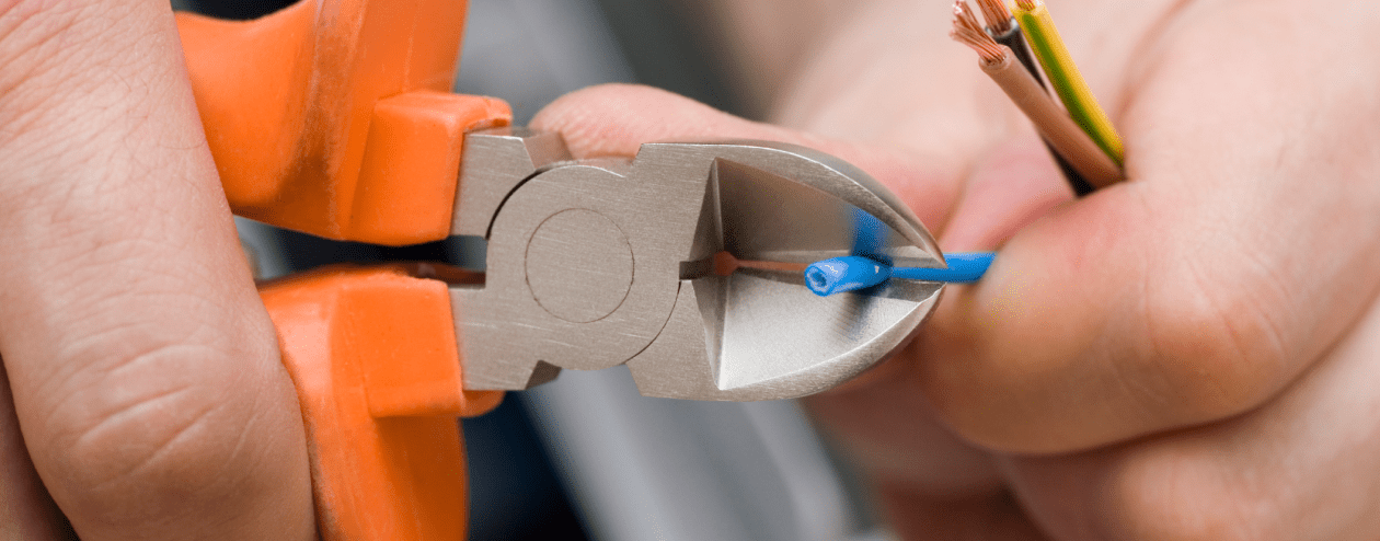 Handyman cutting wiring to solar panels to fix corrosion