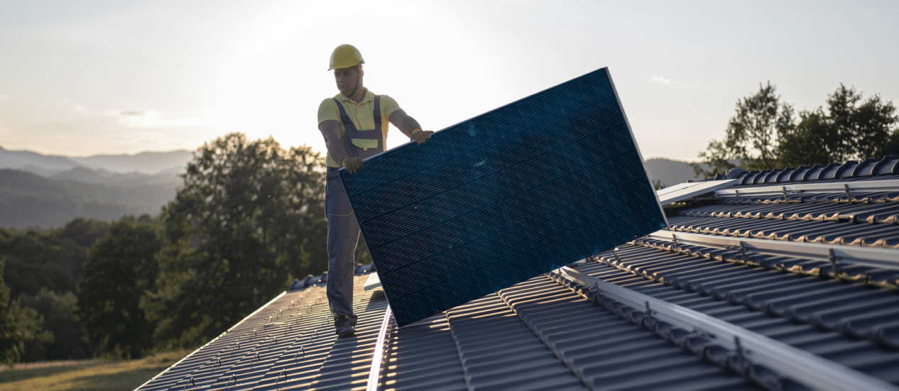 worker holding a solar panel