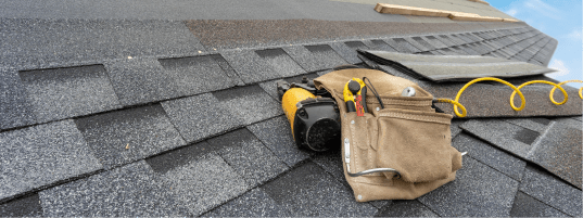 tools and a hammer being used to repair or install a roof